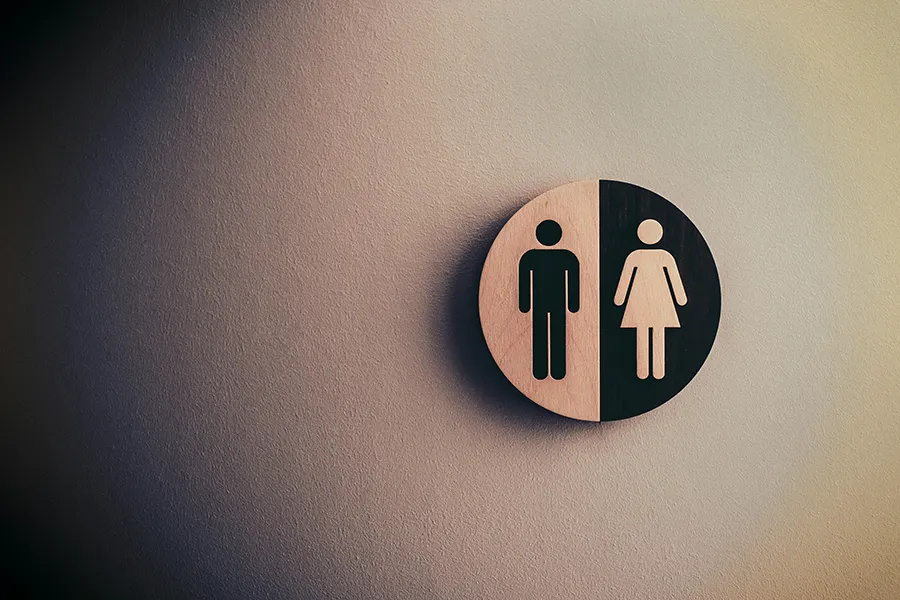 Toilettenschild mit Symbol für Mann und Frau